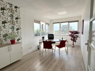 Bureau meublé à louer chez COWORK&Loc' à Sancé, près de Mâcon — bureau lumineux avec mobilier blanc, vue dégagée sur la verdure, idéal pour recevoir des clients